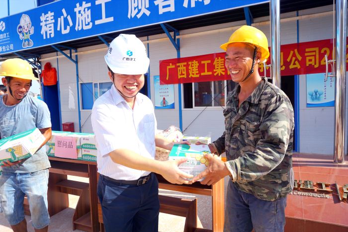 岑廷義為工人發(fā)放清涼慰問品。謝微旋 攝.jpg